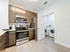 Modern kitchen with stainless steel appliances and laundry in adjacent room at 14501 Grove Resort Ave # 3132, Winter Garden, FL 34787