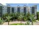 Upscale condo building with palm trees and a gated entrance at 14501 Grove Resort Ave # 3132, Winter Garden, FL 34787