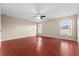Large bedroom with wood-look flooring and two windows at 15606 Kalihna Ct, Orlando, FL 32828