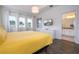 Main bedroom with yellow bedding, and en-suite bathroom access at 487 Marcello Blvd, Kissimmee, FL 34746