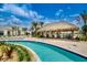 Resort-style pool with tiki bar and lounge chairs at 3161 Paradox Cir # 202, Kissimmee, FL 34746