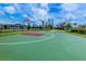 Outdoor basketball court with green and maroon surface at 3161 Paradox Cir # 202, Kissimmee, FL 34746