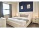 Comfortable main bedroom with a king-size bed and navy blue accent wall at 3161 Paradox Cir # 202, Kissimmee, FL 34746
