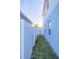 Narrow side yard with grass and a white vinyl fence at 5553 Veneta Way, Saint Cloud, FL 34771