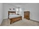 Well-lit bedroom with carpeted floors, wooden furniture, and closet at 7001 Oakwood St, Davenport, FL 33837