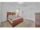 Cozy bedroom with a wooden bed, carpeted floors, and a closet at 7009 Oakwood St, Davenport, FL 33837