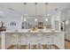 Well-appointed kitchen featuring stainless steel appliances, white countertops, and pendant lighting at 7009 Oakwood St, Davenport, FL 33837