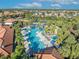 Community pool with palm trees and lounge chairs at 7009 Oakwood St, Davenport, FL 33837