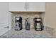 Kitchen coffee bar with granite countertops and two coffee makers at 5424 Solterra Cir # 1, Davenport, FL 33837