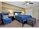 King bedroom with blue bedding and accent chair at 5424 Solterra Cir # 1, Davenport, FL 33837