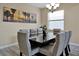 Formal dining room with a table for six and a modern chandelier at 5424 Solterra Cir # 1, Davenport, FL 33837