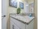 Clean bathroom with granite countertop, single sink, and updated fixtures at 5424 Solterra Cir # 1, Davenport, FL 33837