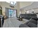Open living room with high ceilings, gray sofas and access to the kitchen at 5424 Solterra Cir # 1, Davenport, FL 33837