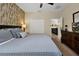 Main bedroom with king-size bed and wood-paneled accent wall at 5424 Solterra Cir # 1, Davenport, FL 33837