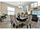 Open concept dining room with seating for six and a view of the living room at 5424 Solterra Cir # 1, Davenport, FL 33837