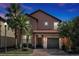 Two-story house with a gray door and brown roof at 5424 Solterra Cir # 1, Davenport, FL 33837