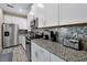 Modern kitchen with stainless steel appliances and granite countertops at 5424 Solterra Cir # 1, Davenport, FL 33837