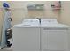Laundry room with washer, dryer, and shelving for storage at 5424 Solterra Cir # 1, Davenport, FL 33837