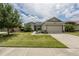 Single story home with two-car garage and landscaped yard at 8286 Bridgeport Bay Cir, Mount Dora, FL 32757