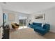 Bright living room featuring a comfortable sectional sofa and sliding glass doors leading to the backyard at 117 Eagleview Loop, Davenport, FL 33837