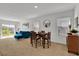 Casual dining area with a table and chairs, blue couch and sliding glass doors at 117 Eagleview Loop, Davenport, FL 33837