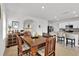 Elegant dining room with a large wooden table and access to the kitchen at 117 Eagleview Loop, Davenport, FL 33837