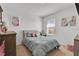 Bright bedroom with a queen bed, window, and decorative wall art at 117 Eagleview Loop, Davenport, FL 33837