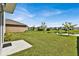 Large backyard with a patio, pond view, and lush lawn at 117 Eagleview Loop, Davenport, FL 33837