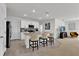 Open kitchen with island, granite countertops, and stainless steel appliances at 117 Eagleview Loop, Davenport, FL 33837