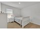 Cozy bedroom with a full-size bed and window at 117 Eagleview Loop, Davenport, FL 33837