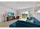 Spacious living area with L-shaped sofa, backyard view, and ample natural light at 117 Eagleview Loop, Davenport, FL 33837