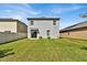 Spacious backyard with a two-story home and green grass at 117 Eagleview Loop, Davenport, FL 33837