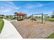 Community playground with swings, slides, and a covered pavilion at 117 Eagleview Loop, Davenport, FL 33837
