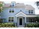 Two-story light blue home with a black door and white trim at 3478 Westchester Square Blvd # 202, Orlando, FL 32835