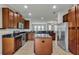 Kitchen with island, stainless steel appliances, and wood cabinets at 8217 De Haven Street, Orlando, FL 32832