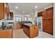 Kitchen with island, stainless steel appliances, and wood cabinets at 8217 De Haven Street, Orlando, FL 32832
