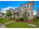 Two-story house with neutral exterior and front yard landscaping at 8217 De Haven Street, Orlando, FL 32832