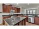 Kitchen with dark wood cabinets and granite countertops at 8217 De Haven Street, Orlando, FL 32832