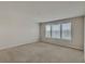 Spacious bedroom with neutral carpeting and three windows at 8217 De Haven Street, Orlando, FL 32832