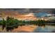Scenic lake view with lush trees and sunset sky at 8217 De Haven Street, Orlando, FL 32832
