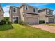 Two-story house with a two-car garage and landscaped lawn at 8217 De Haven Street, Orlando, FL 32832