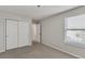 Simple bedroom with double door closet and window with blinds at 8217 De Haven Street, Orlando, FL 32832