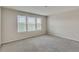 Spacious bedroom with neutral carpeting and three windows at 8217 De Haven Street, Orlando, FL 32832