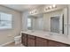Bathroom with double vanity, mirror, and shower/tub combo at 8217 De Haven Street, Orlando, FL 32832