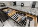 Well-organized kitchen drawer with various cooking utensils at 2428 Dubai St, Kissimmee, FL 34747