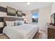 Spacious bedroom with king-size bed, dresser, and large window at 2428 Dubai St, Kissimmee, FL 34747