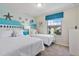 Twin bedroom with ocean theme, two beds, and plenty of natural light at 2428 Dubai St, Kissimmee, FL 34747