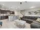 Spacious living room with grey sectional sofa and large flat-screen TV at 2428 Dubai St, Kissimmee, FL 34747