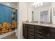 Bathroom with granite countertop, double sinks, and Minions shower curtain at 2428 Dubai St, Kissimmee, FL 34747