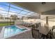 Private screened pool with lounge chairs and patio furniture at 2428 Dubai St, Kissimmee, FL 34747